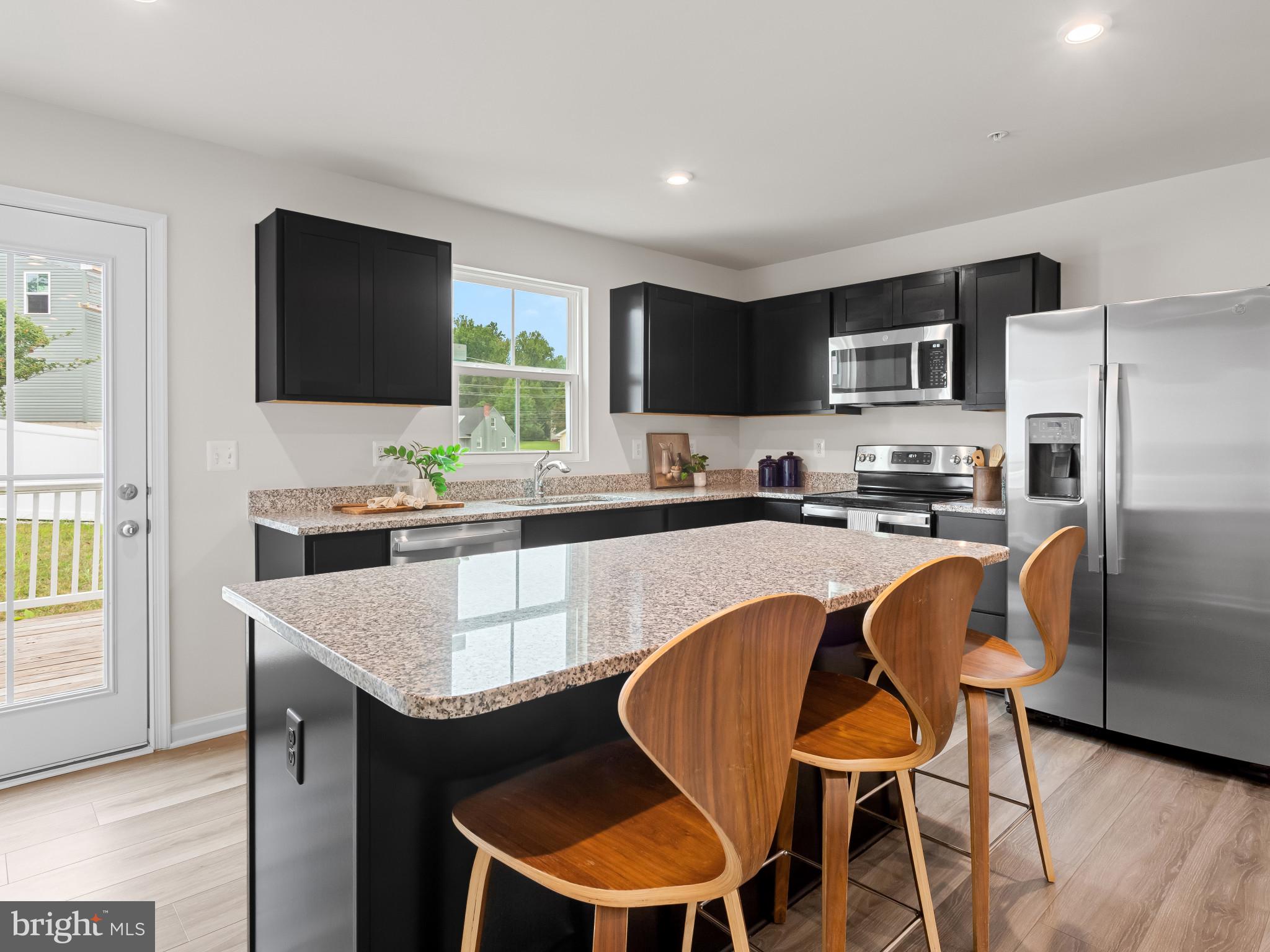 5505 Vergo Road Capitol Heights, MD 20743 - Photo 8 of 42 a kitchen with a dining table and chairs