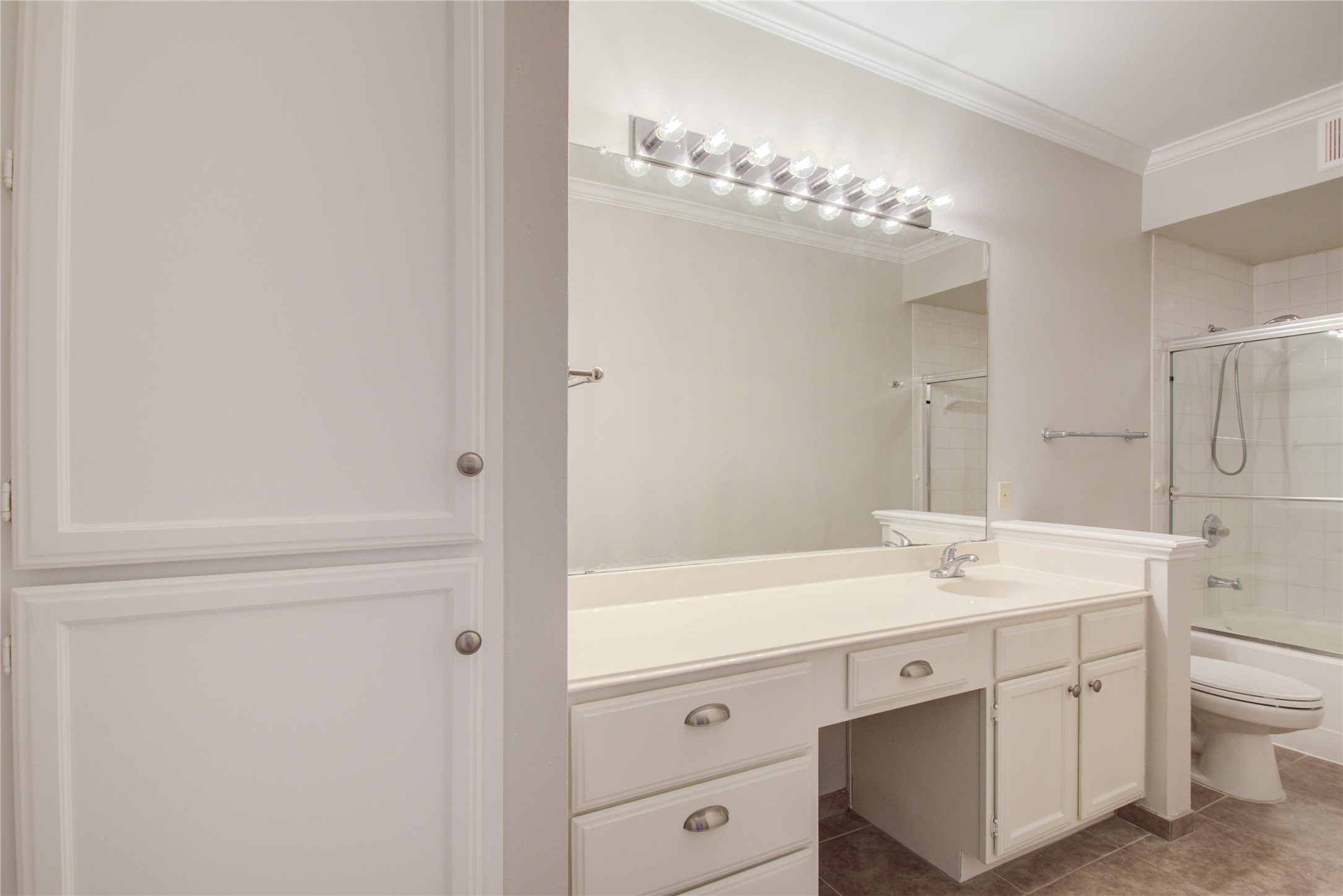 2111 Welch Street, Unit A321 Houston, TX 77019 - Photo 13 of 25 a bathroom with a sink a vanity and a mirror