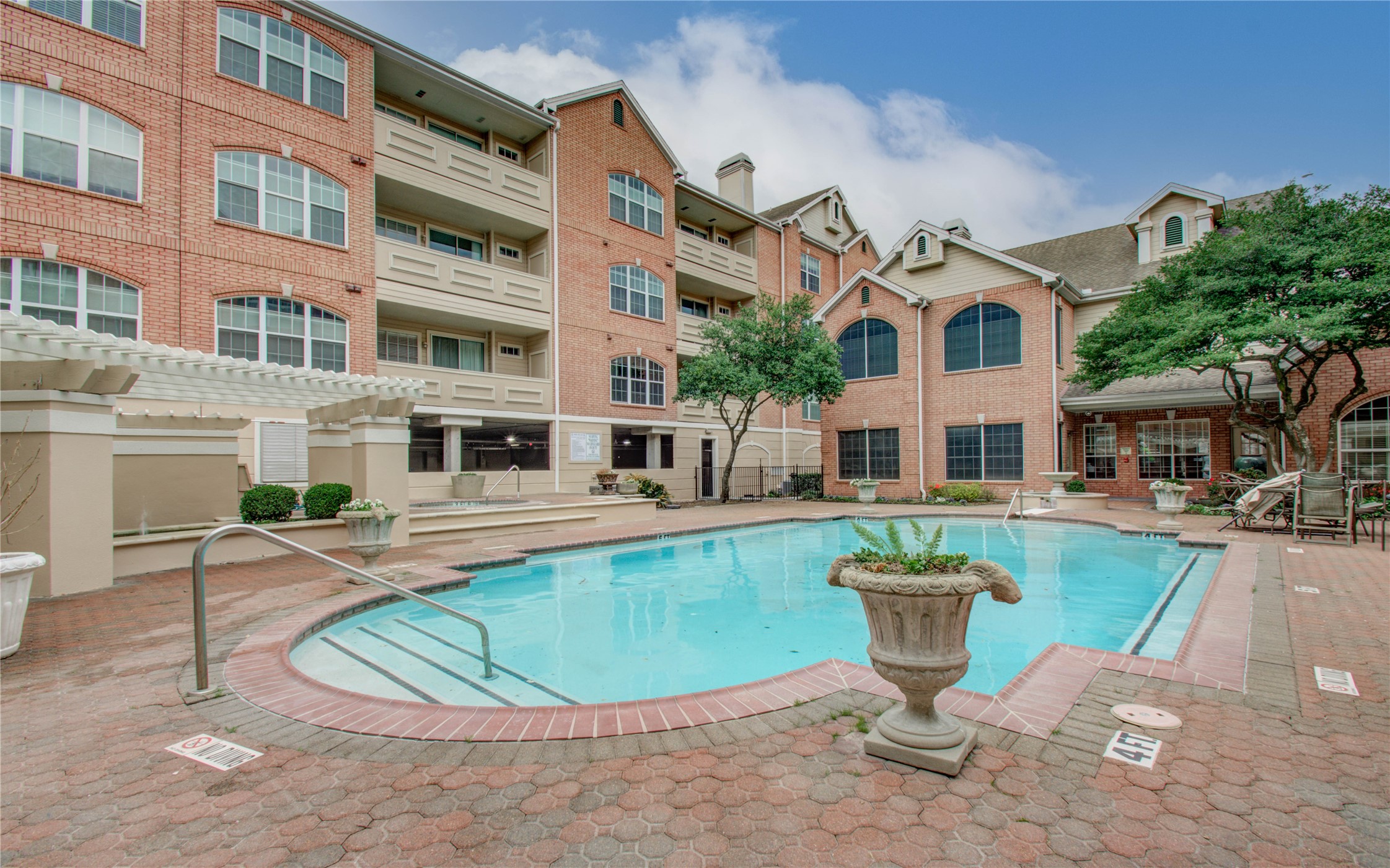 2111 Welch Street, Unit A321 Houston, TX 77019 - Photo 24 of 25 a view of a white building with swimming pool in front of it