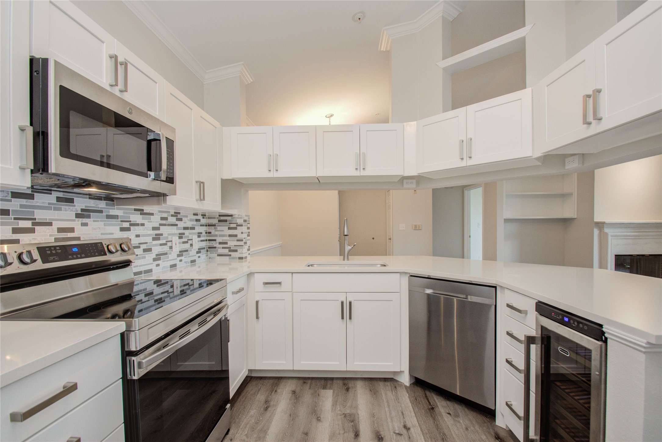 2111 Welch Street, Unit A321 Houston, TX 77019 - Photo 5 of 25 a kitchen with a sink stove and microwave