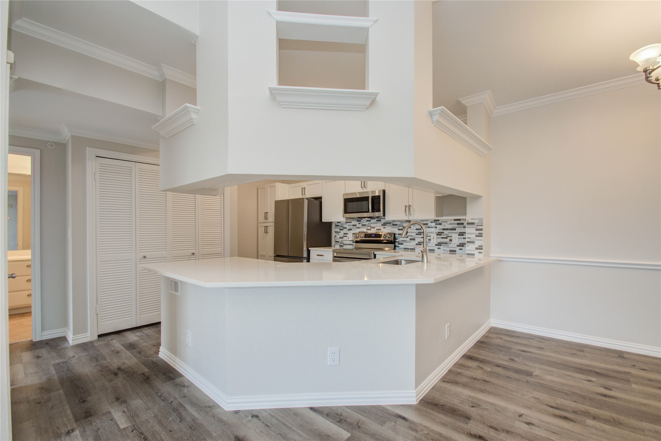 2111 Welch Street, Unit A321 Houston, TX 77019 - Photo 7 of 25 a kitchen with stainless steel appliances a sink and a stove