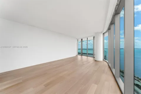 a view of an empty room with glass door
