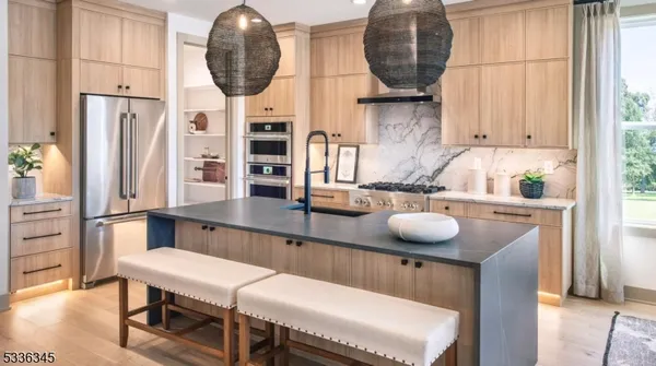 a kitchen with stainless steel appliances a sink and a table