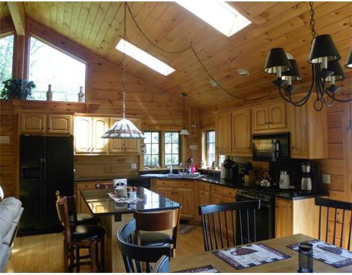 33 Town Farm Road Heath, MA 01346 - Photo 4 of 22 a kitchen with a table chairs and a chandelier