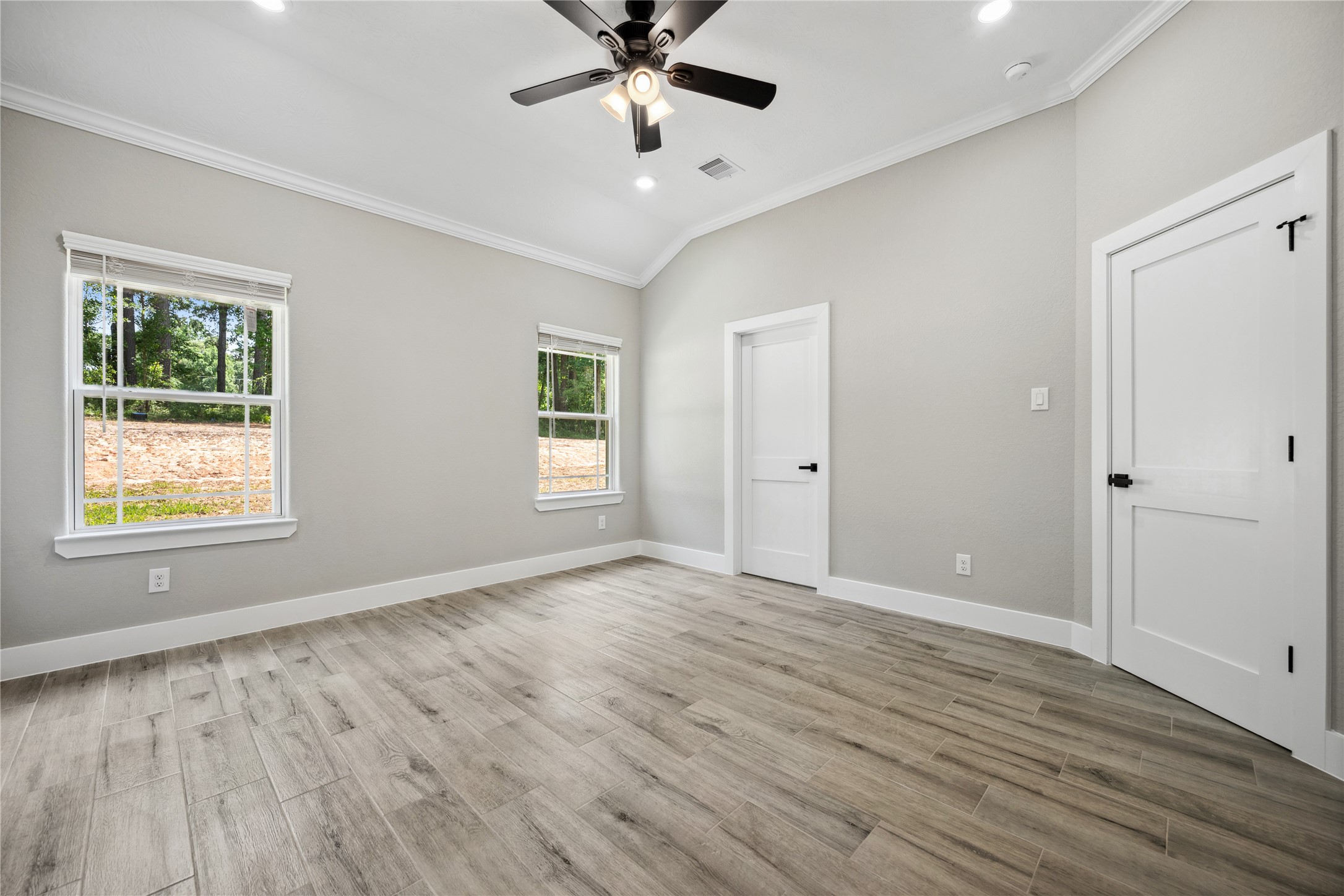 139 Popular Street Onalaska, TX 77360 - Photo 15 of 24 a view of an empty room with a window and wooden floor