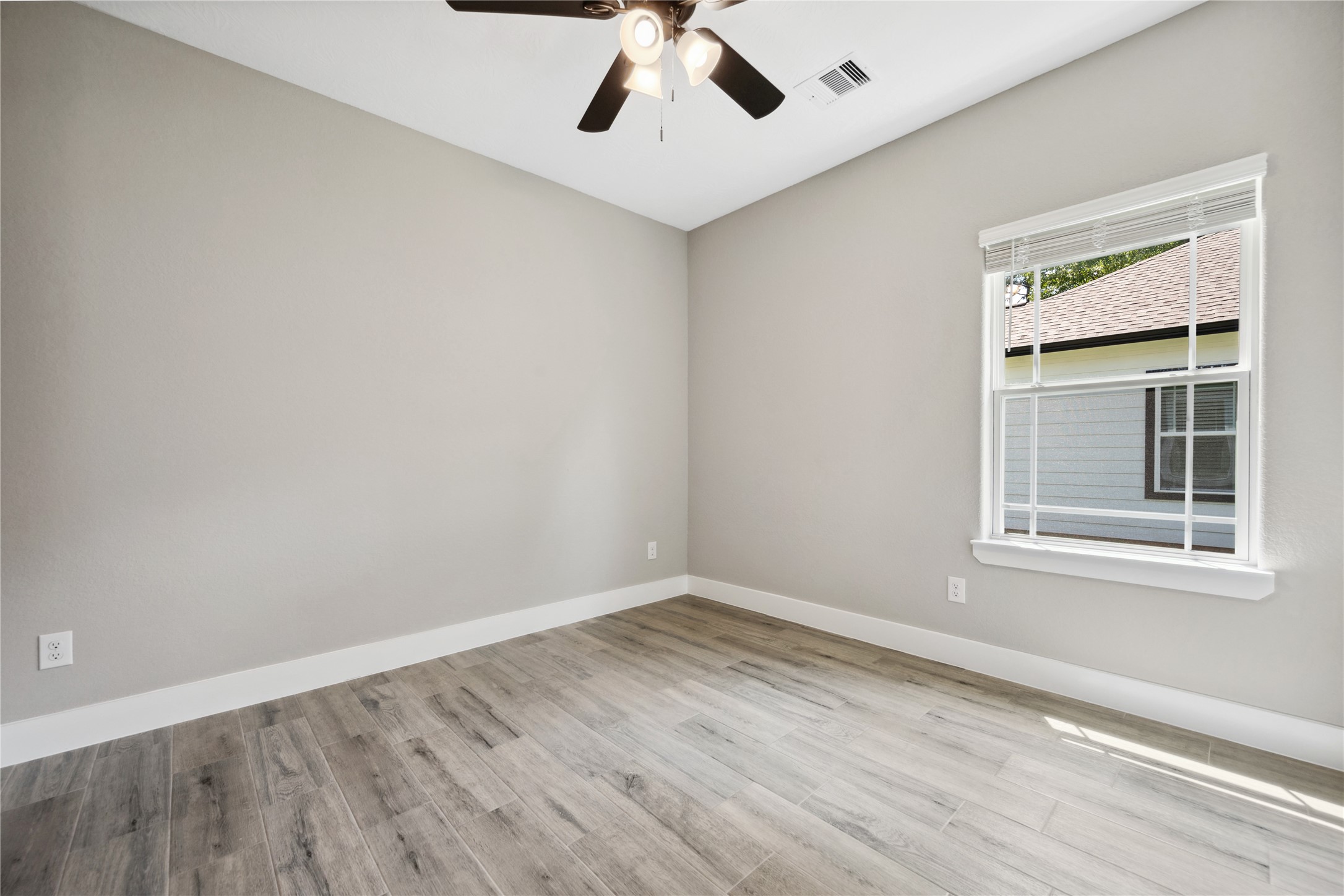 139 Popular Street Onalaska, TX 77360 - Photo 21 of 24 wooden floor in an empty room with a window
