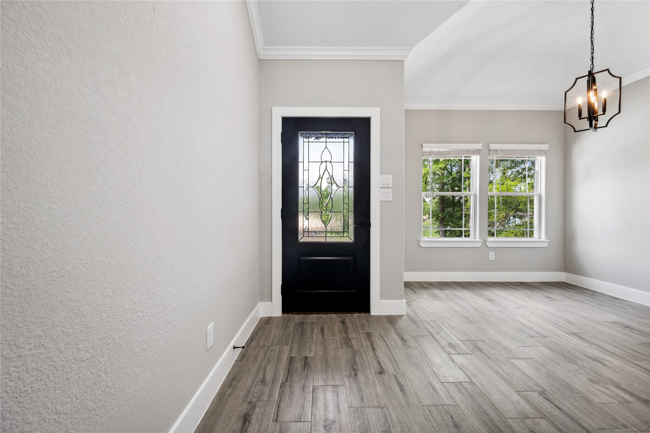 139 Popular Street Onalaska, TX 77360 - Photo 3 of 24 a view of an empty room with wooden floor and a window