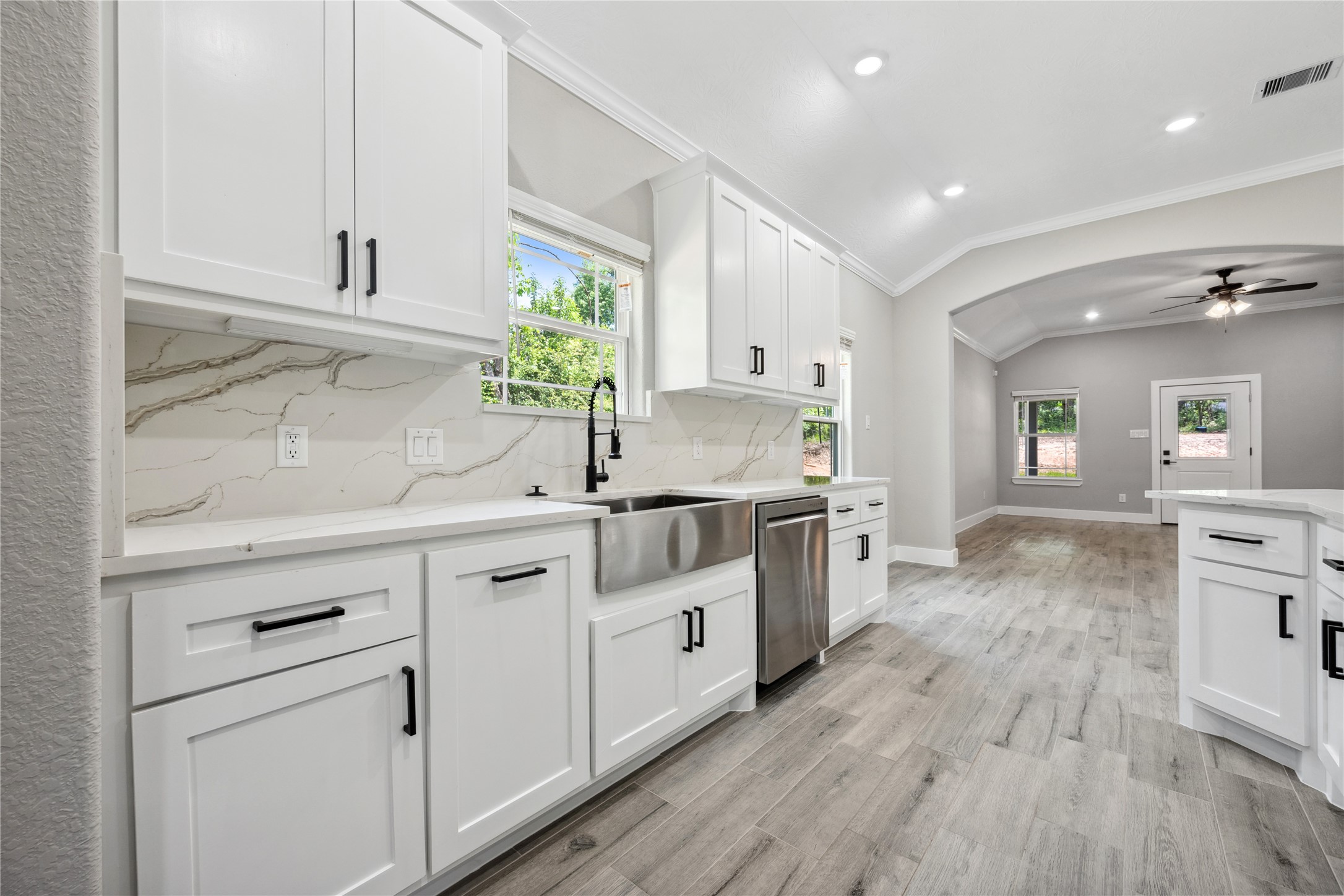 139 Popular Street Onalaska, TX 77360 - Photo 10 of 24 a kitchen with stainless steel appliances white cabinets and wooden floors
