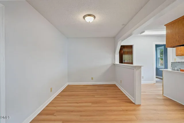 a view of a room with wooden floor and windows