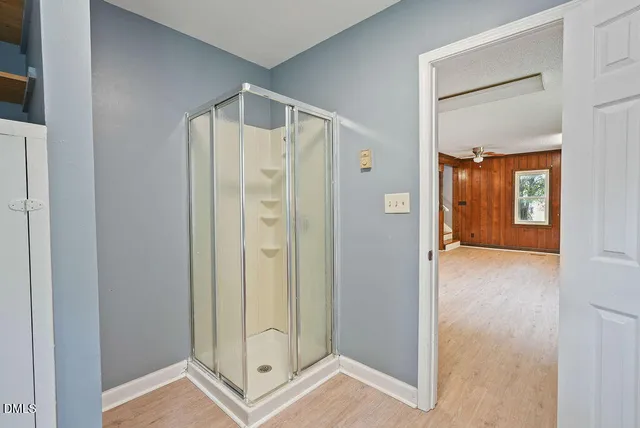 a bathroom with a shower and a glass door