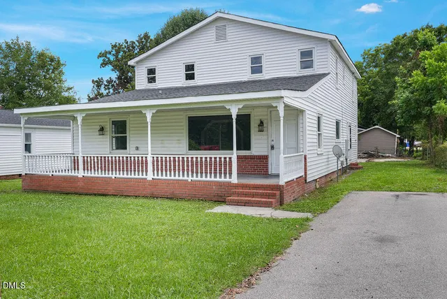 a view of a house with a yard and plants