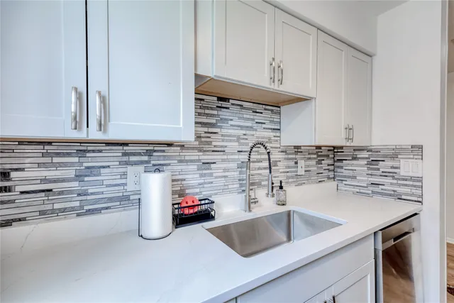 a kitchen with a sink and cabinets