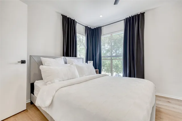 a bedroom with a large bed and a large window