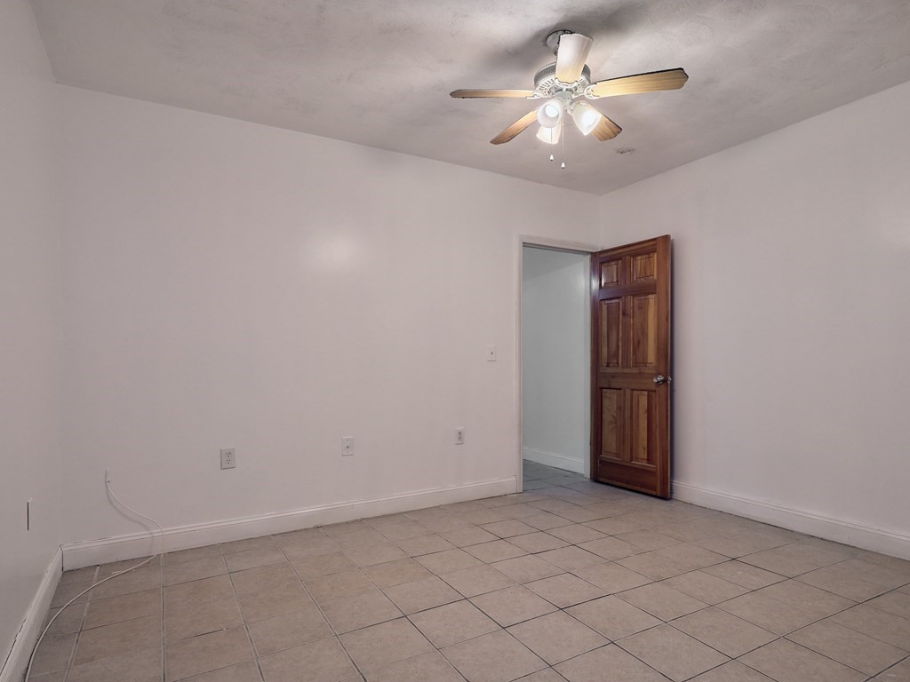 455 Washington Street Haverhill, MA 01832 - Photo 14 of 42 an empty room with a chandelier fan
