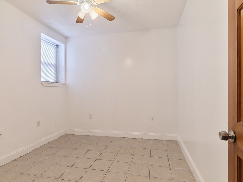 455 Washington Street Haverhill, MA 01832 - Photo 16 of 42 an empty room with a chandelier fan