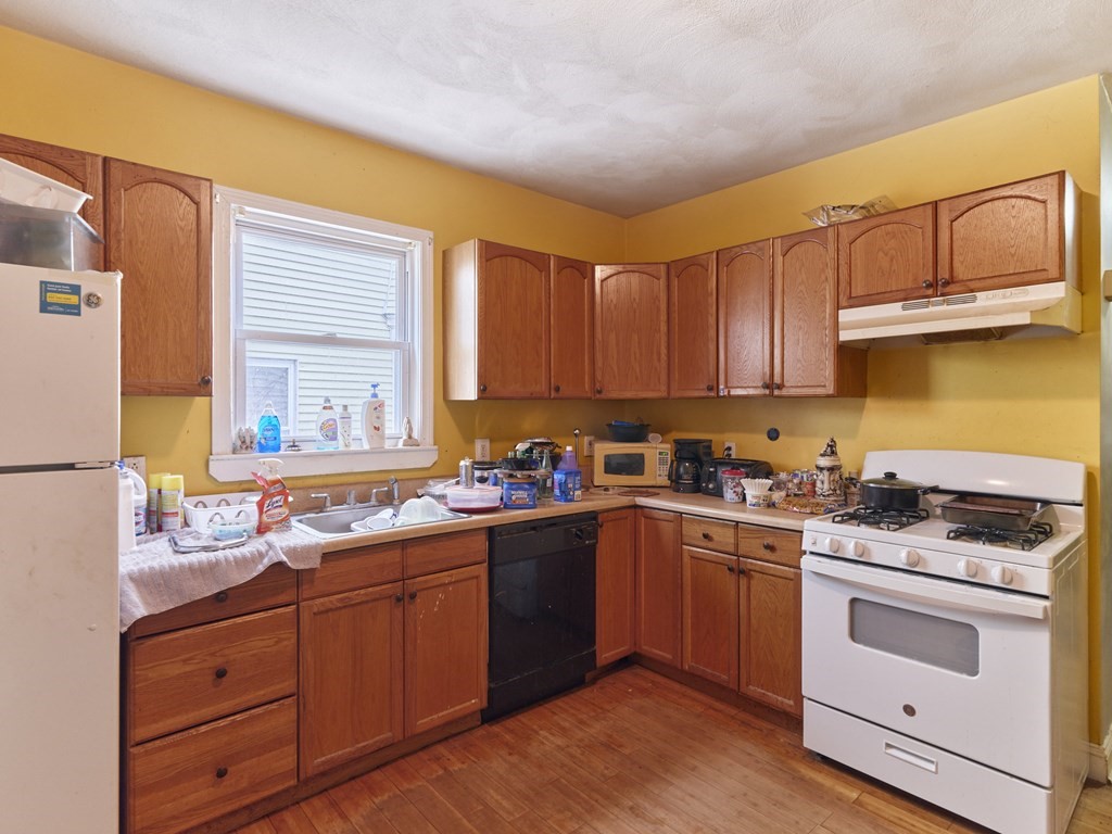 455 Washington Street Haverhill, MA 01832 - Photo 19 of 42 a kitchen with stainless steel appliances granite countertop a sink stove and refrigerator