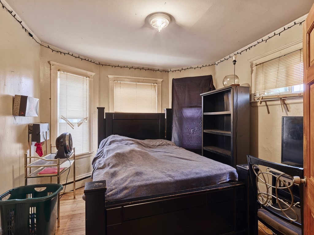 455 Washington Street Haverhill, MA 01832 - Photo 20 of 42 a bedroom with a bed and a flat tv screen on the dresser