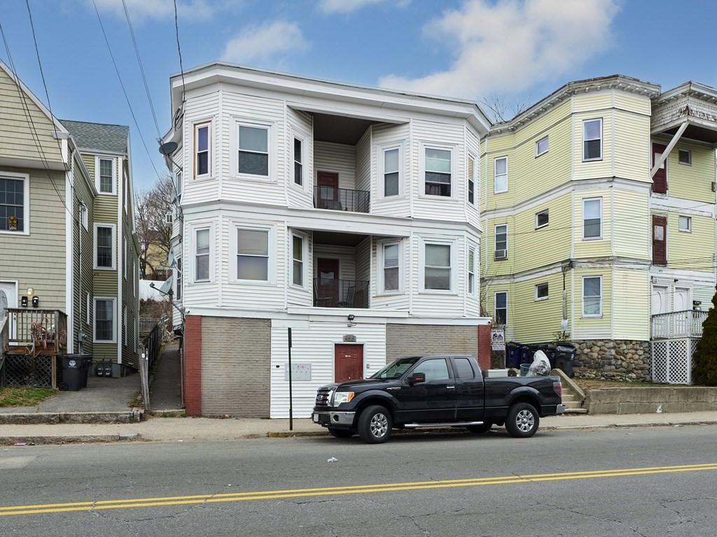455 Washington Street Haverhill, MA 01832 - Photo 2 of 42 a car parked in front of a white building