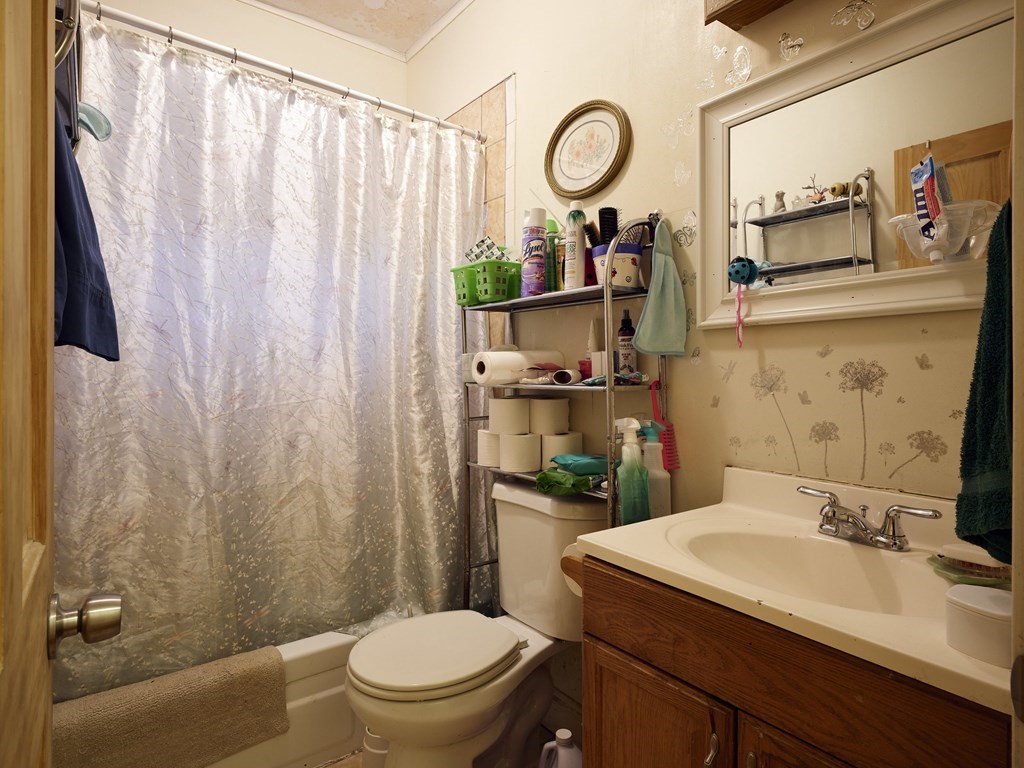 455 Washington Street Haverhill, MA 01832 - Photo 33 of 42 a bathroom with a sink a toilet and a mirror
