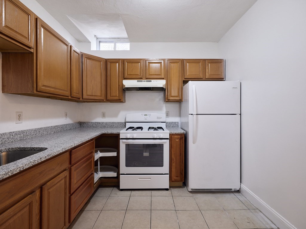 455 Washington Street Haverhill, MA 01832 - Photo 6 of 42 a kitchen with a white cabinets and white appliances