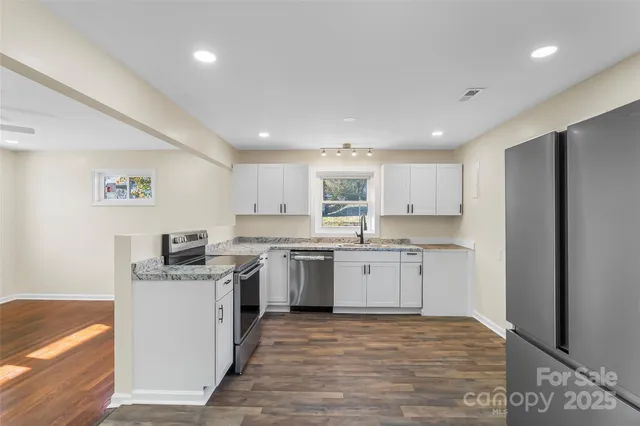 a kitchen with a sink stove and refrigerator