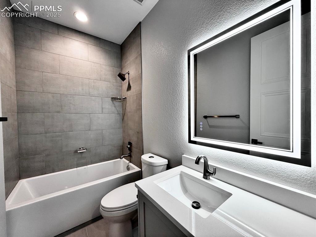 3155 Promise Point Colorado Springs, CO 80921 - Photo 5 of 26 a bathroom with a sink mirror toilet and bathtub