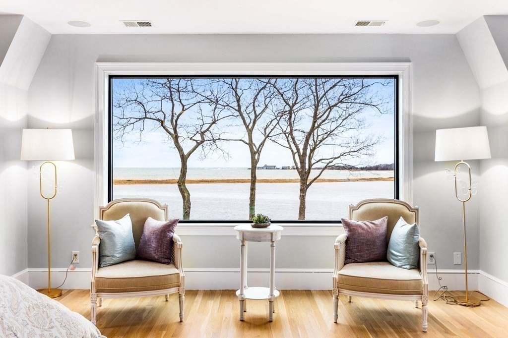 a living room with a couch and a potted plant