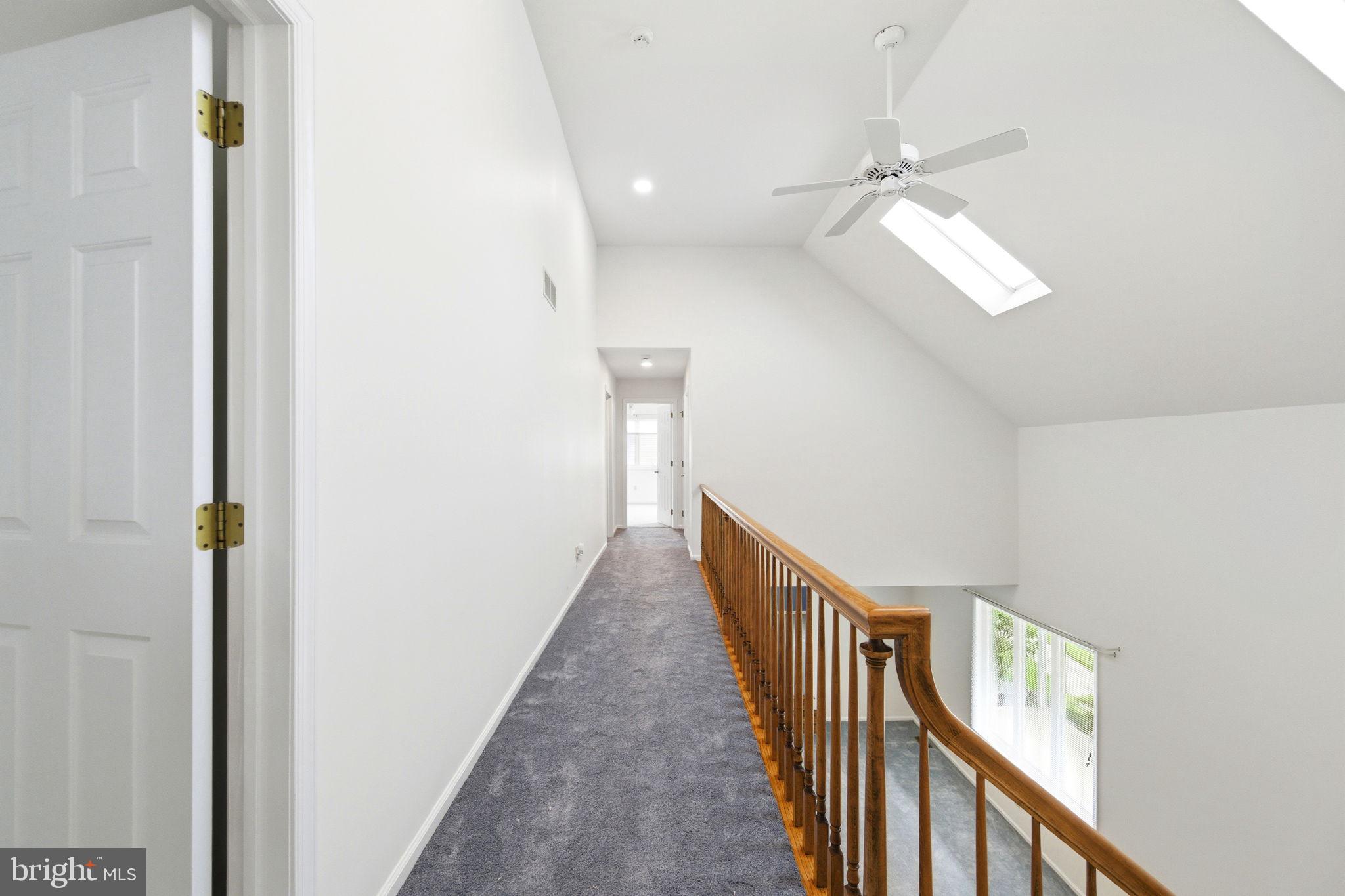 736 Letitia Drive Hockessin, DE 19707 - Photo 50 of 92 a view of a hallway with wooden floor and staircase