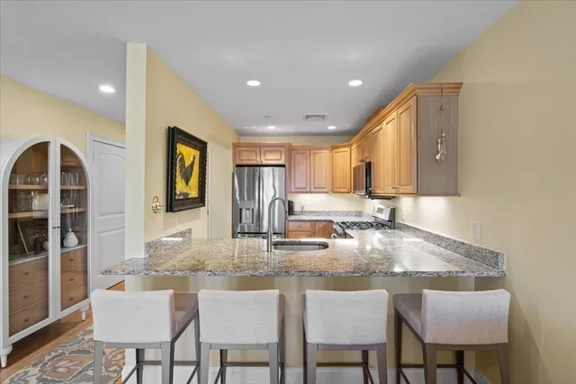a kitchen with kitchen island granite countertop a table and chairs