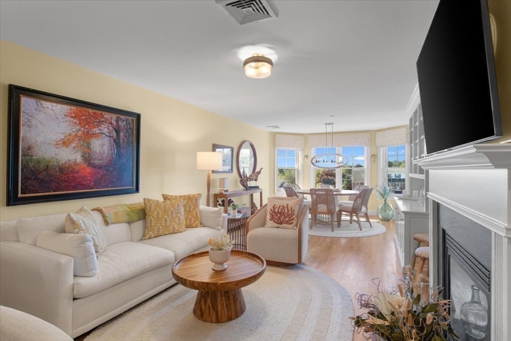 91 Front Street, Unit 308 Scituate, MA 02066 - Photo 14 of 27 a living room with furniture a rug and white walls