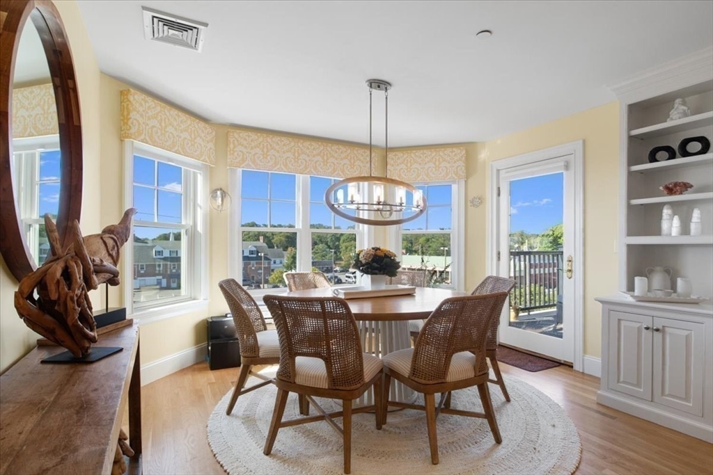 91 Front Street, Unit 308 Scituate, MA 02066 - Photo 16 of 27 a view of a dining room with furniture window and wooden floor