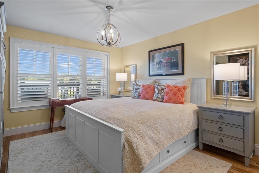 91 Front Street, Unit 308 Scituate, MA 02066 - Photo 19 of 27 a bedroom with a bed and a window