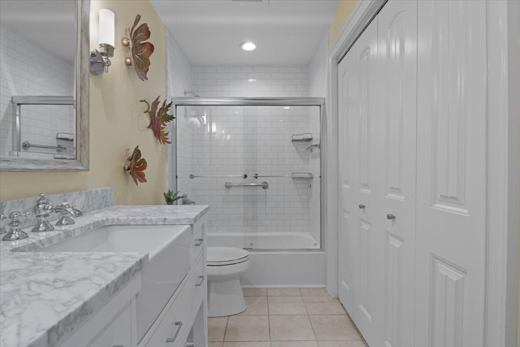 91 Front Street, Unit 308 Scituate, MA 02066 - Photo 23 of 27 a bathroom with a granite countertop sink a toilet and shower
