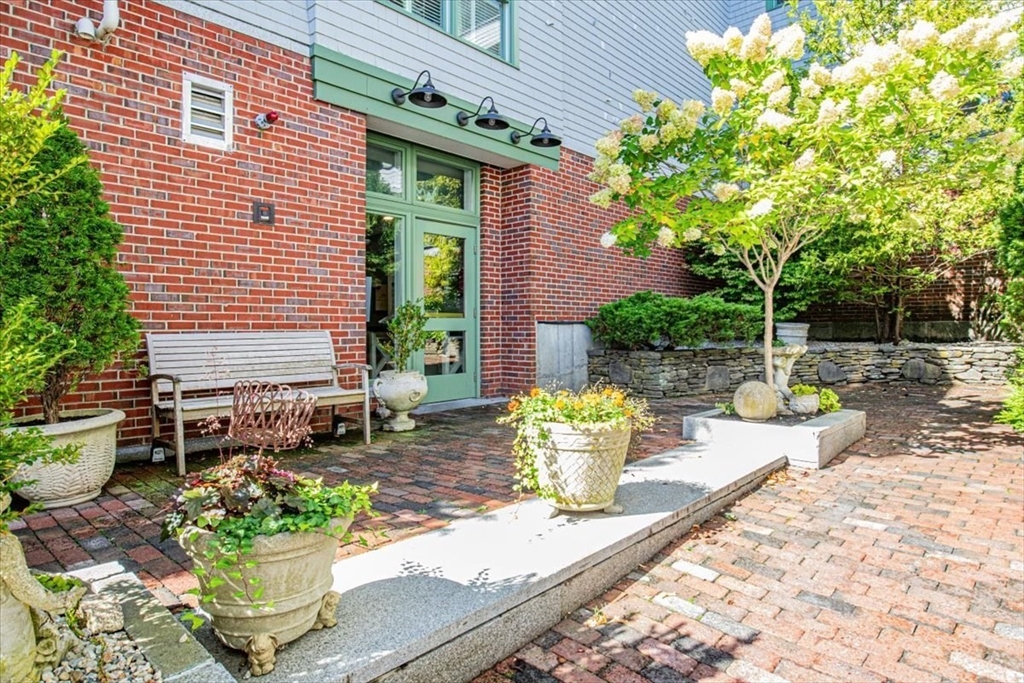 91 Front Street, Unit 308 Scituate, MA 02066 - Photo 7 of 27 a view of a patio with table and chairs and potted plants