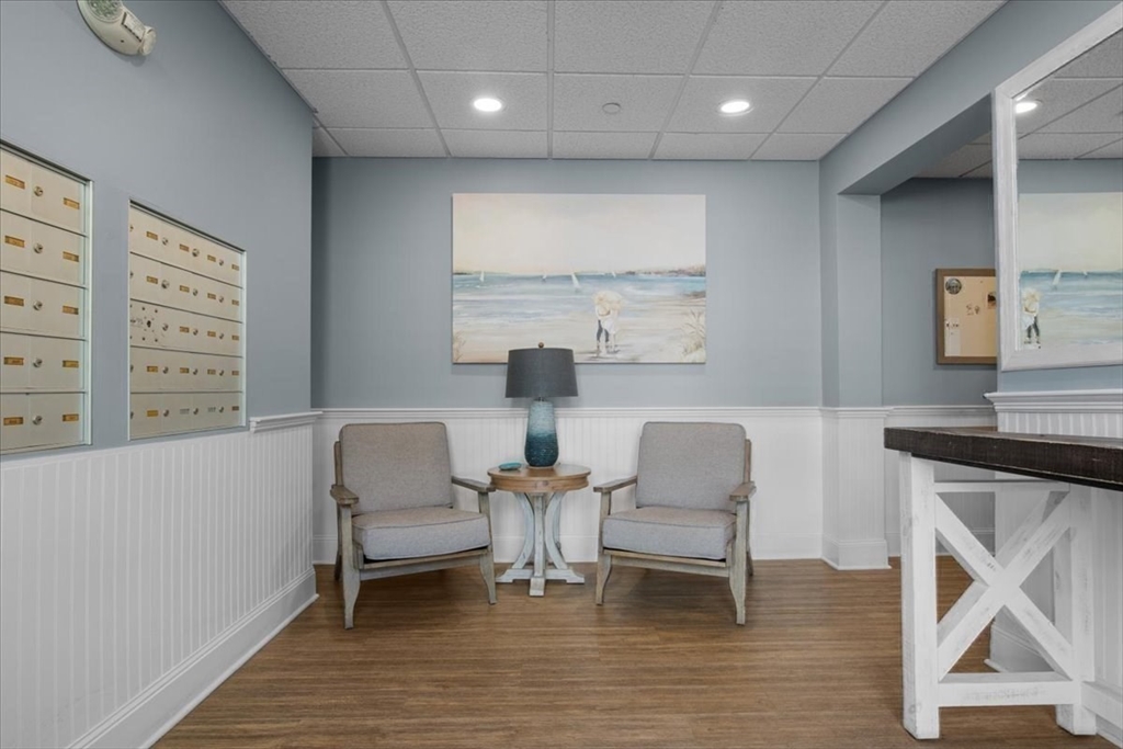 91 Front Street, Unit 308 Scituate, MA 02066 - Photo 8 of 27 a dining room with furniture and a floor to ceiling window