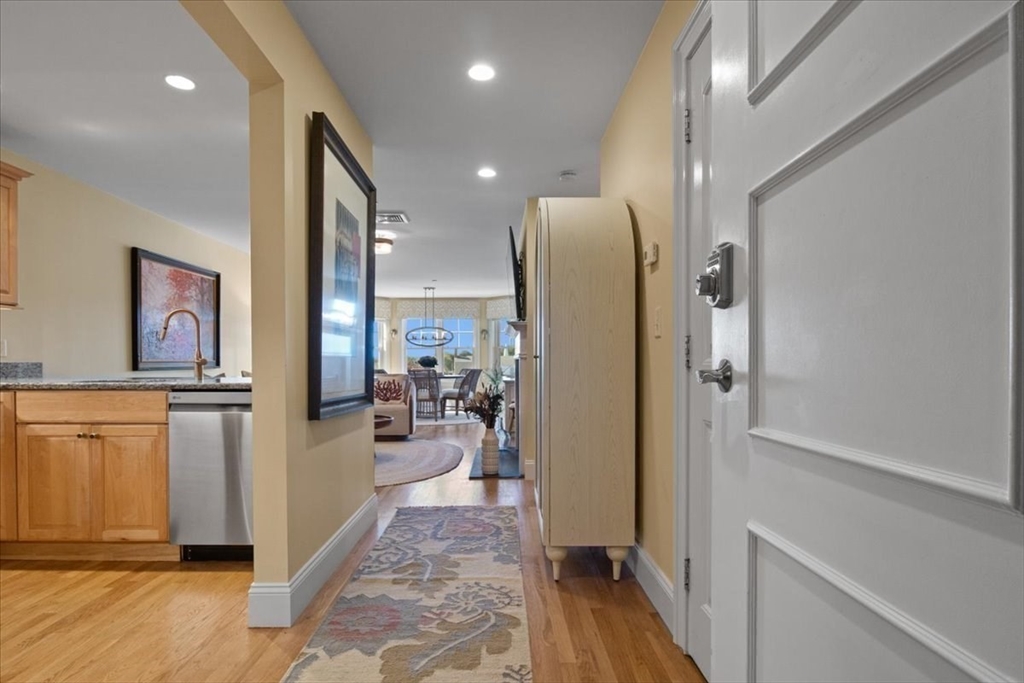 91 Front Street, Unit 308 Scituate, MA 02066 - Photo 9 of 27 a view of a hallway with living room and furniture