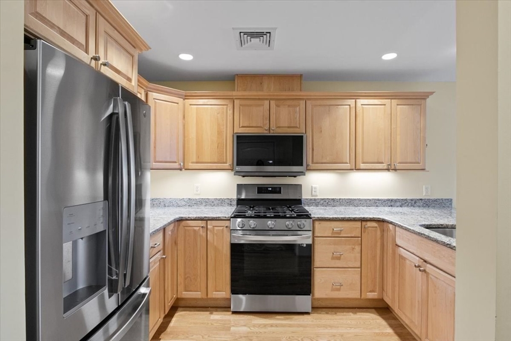 91 Front Street, Unit 308 Scituate, MA 02066 - Photo 10 of 27 a kitchen with a refrigerator stove and microwave