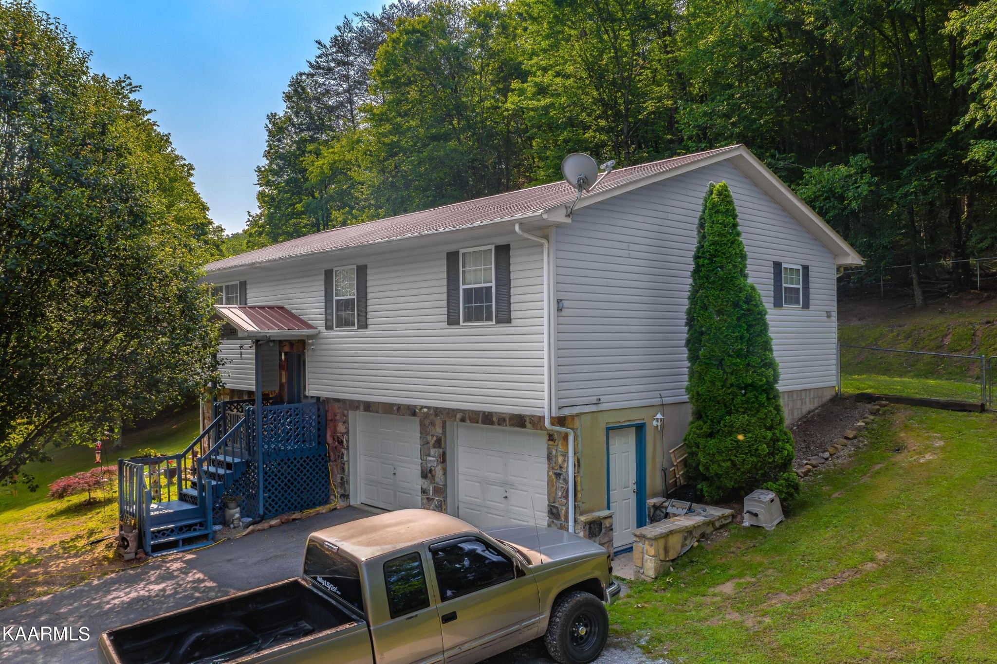 3226 Bogard Road Cosby, TN 37722 - Photo 1 of 35 a front view of a house with garden