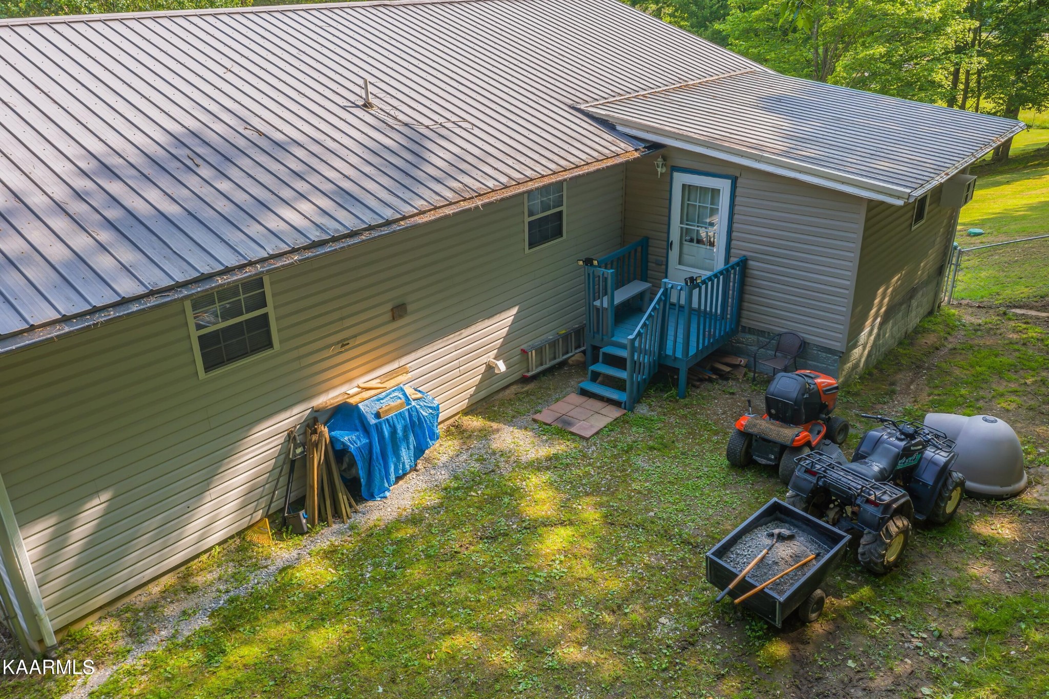 3226 Bogard Road Cosby, TN 37722 - Photo 28 of 35 a backyard of a house with wooden floor chairs sofa and barbecue grill