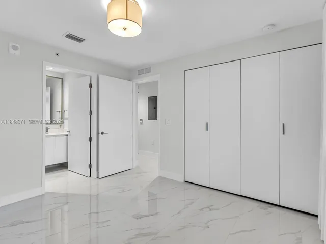 an empty room with windows and entrance