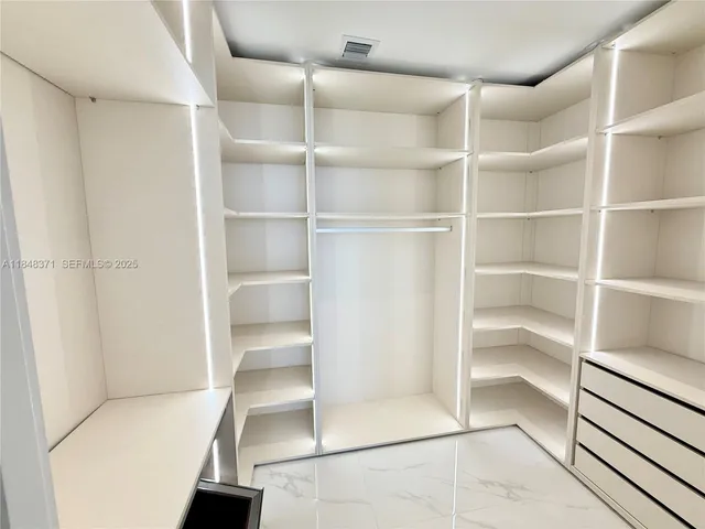 a view of a chair and table in the garden