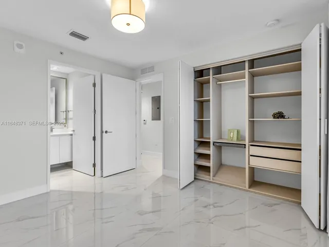 a dining room with furniture and a potted plant