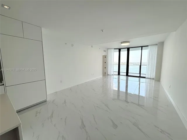 an entryway with white walls and windows