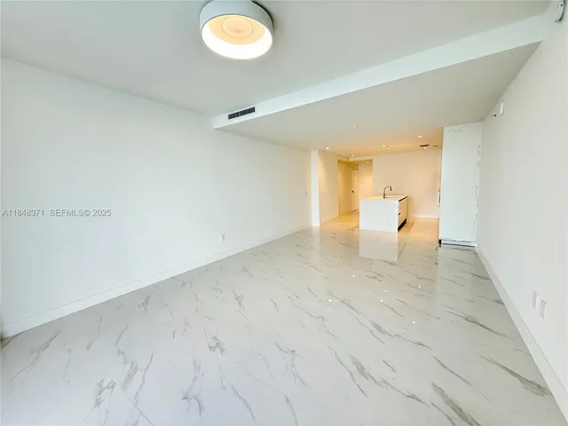 an empty room with windows and entrance