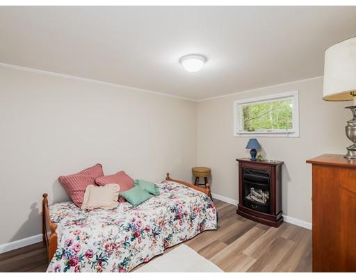 276 Lakeview Drive Winchendon, MA 01475 - Photo 16 of 37 a bed room with a bed and a fireplace