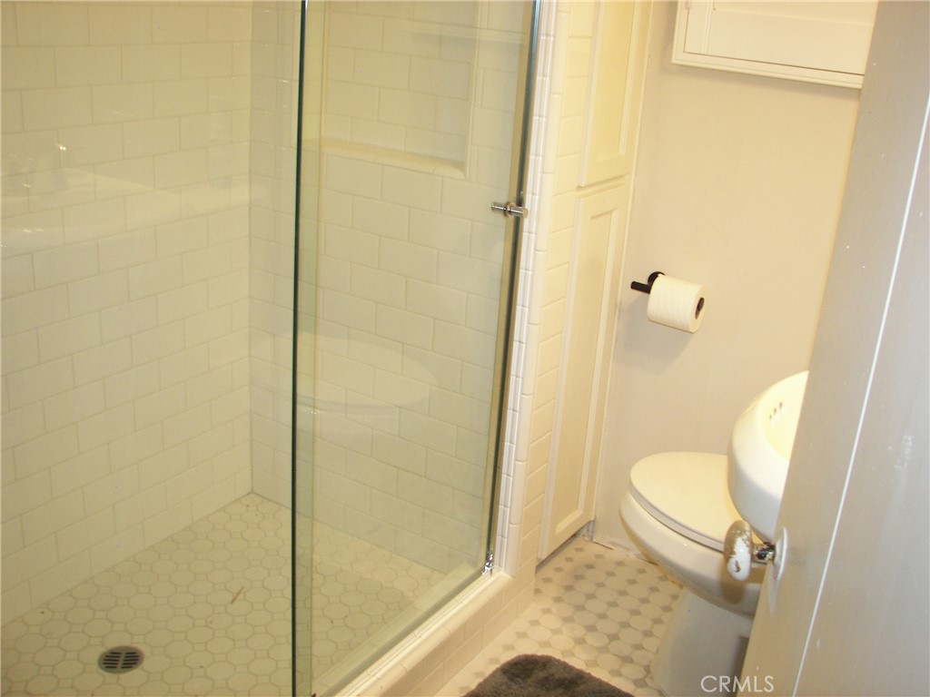 1101 Big Tree Lane Crestline, CA 92325 - Photo 17 of 30 a bathroom with a granite countertop toilet and a shower