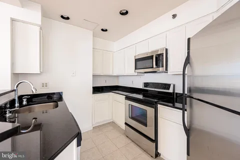 a kitchen with stainless steel appliances granite countertop a stove and a microwave
