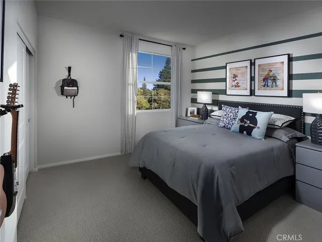 a bedroom with a bed and window