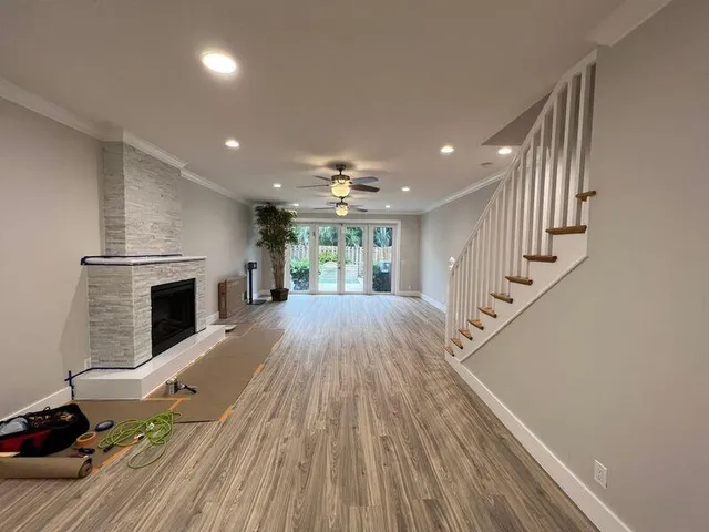 a view of a livingroom with wooden floor and staircase
