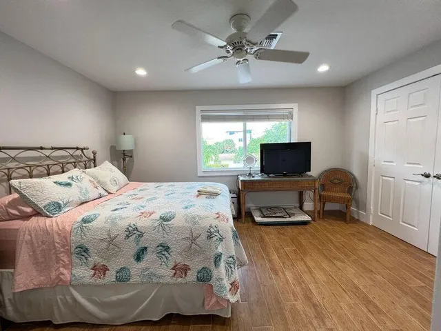 a bedroom with a bed and a flat screen tv